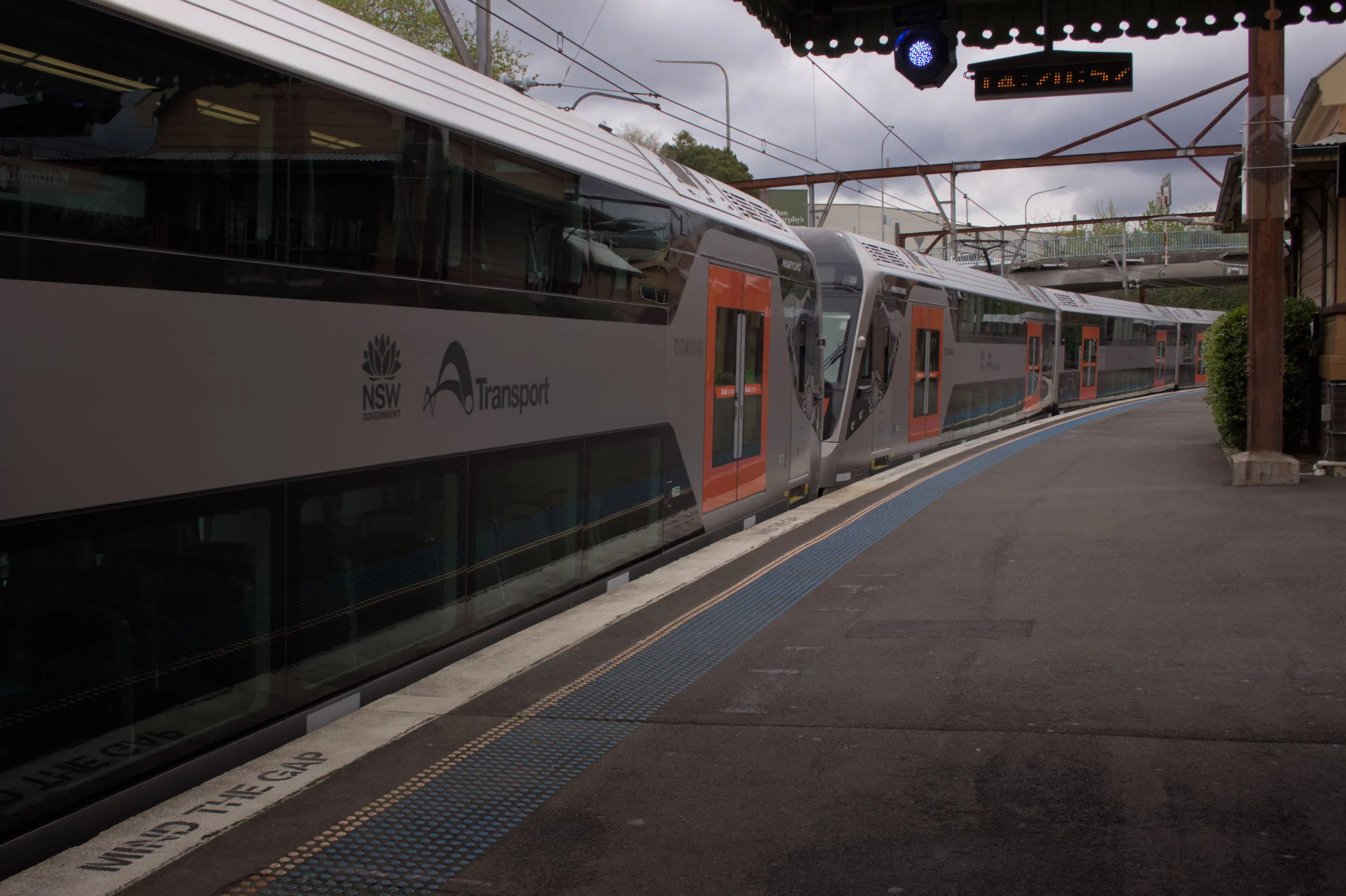 A ten car Mariyung set stops breifly at the curved platform at Katoomba on an overcast day during testing. This set was led by D140